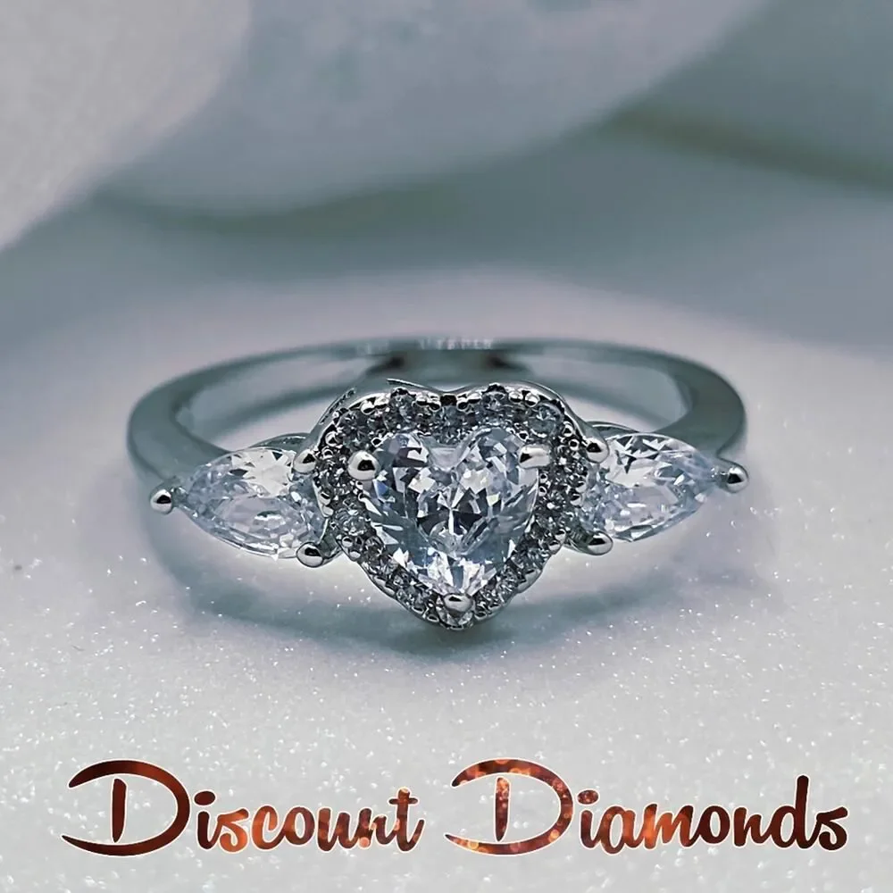 White Heart Shaped Diamond Ring Flanked by 2 Diamonds &  Baguette Diamonds & 925